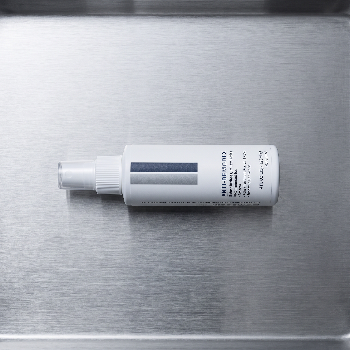 DemodexCillin Skin Solution, overhead view on brushed steel